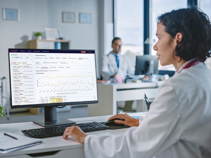 Woman At Computer With Visible Screen