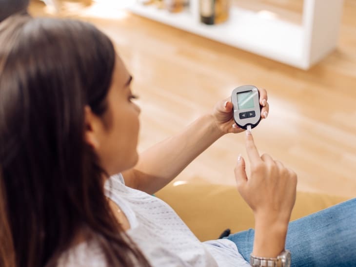 Woman Doing A Blood Sugar Test At Home